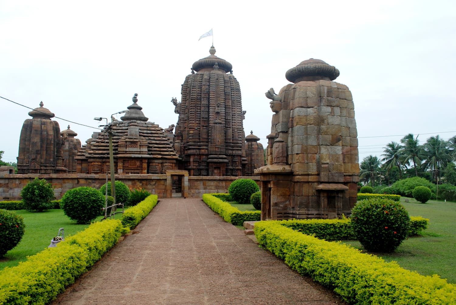The Brahmeswara Temple and its corner shrines at the end of a garden path