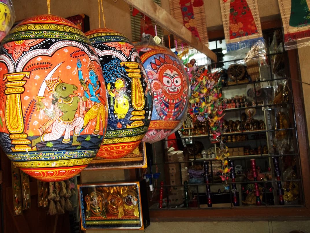Painted lanterns and handicrafts on display at a stall in Ekamra Haat