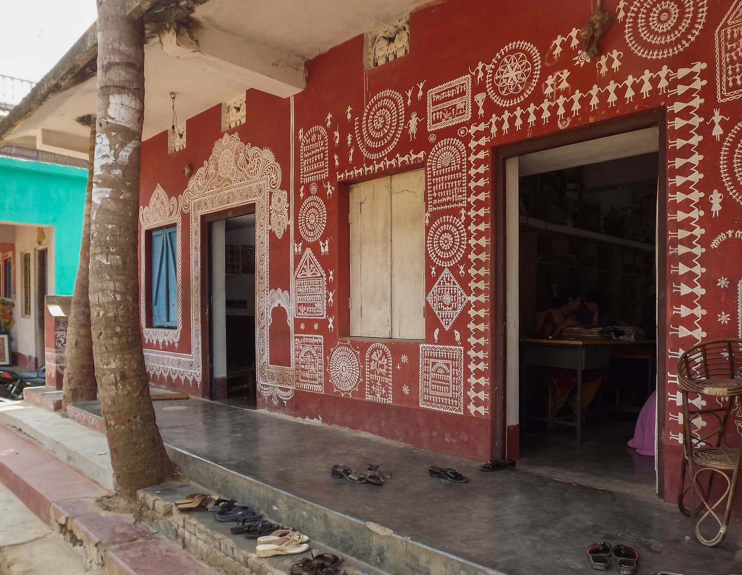 A village house in Raghurajpur with walls painted in red and white patterns