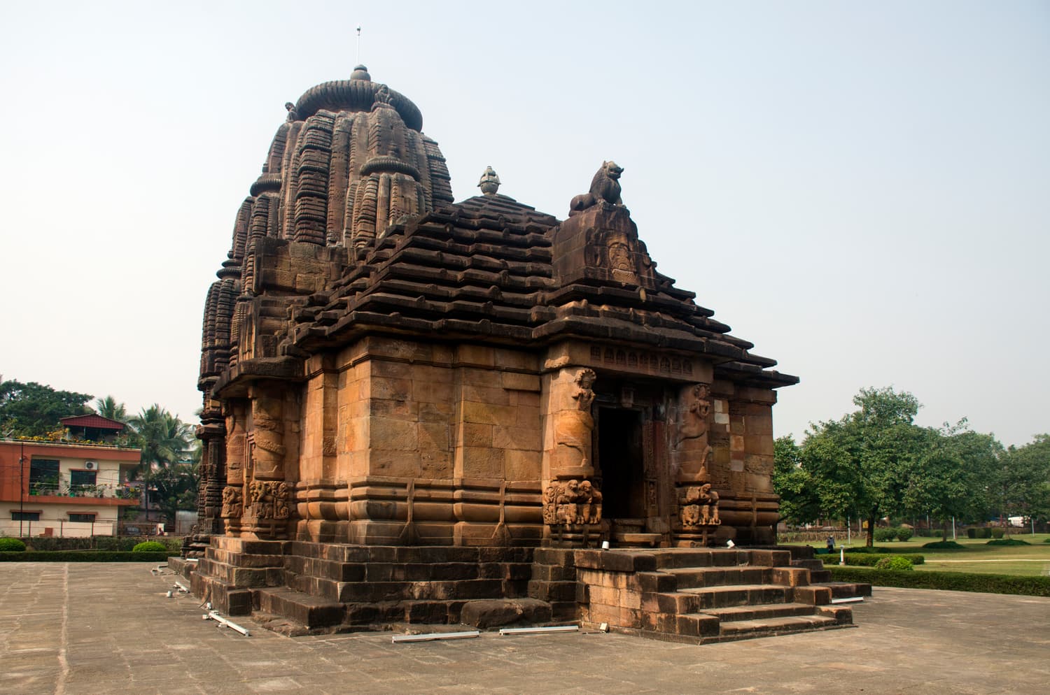 The Rajarani Temple’s carved tower standing in a green lawn