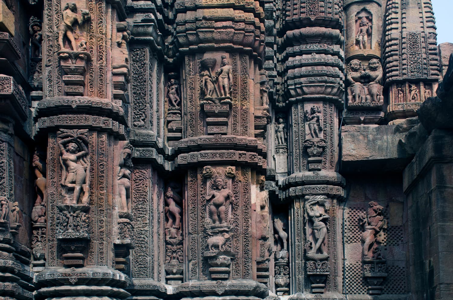 Densely carved figures and miniature towers on the walls of the Rajarani Temple